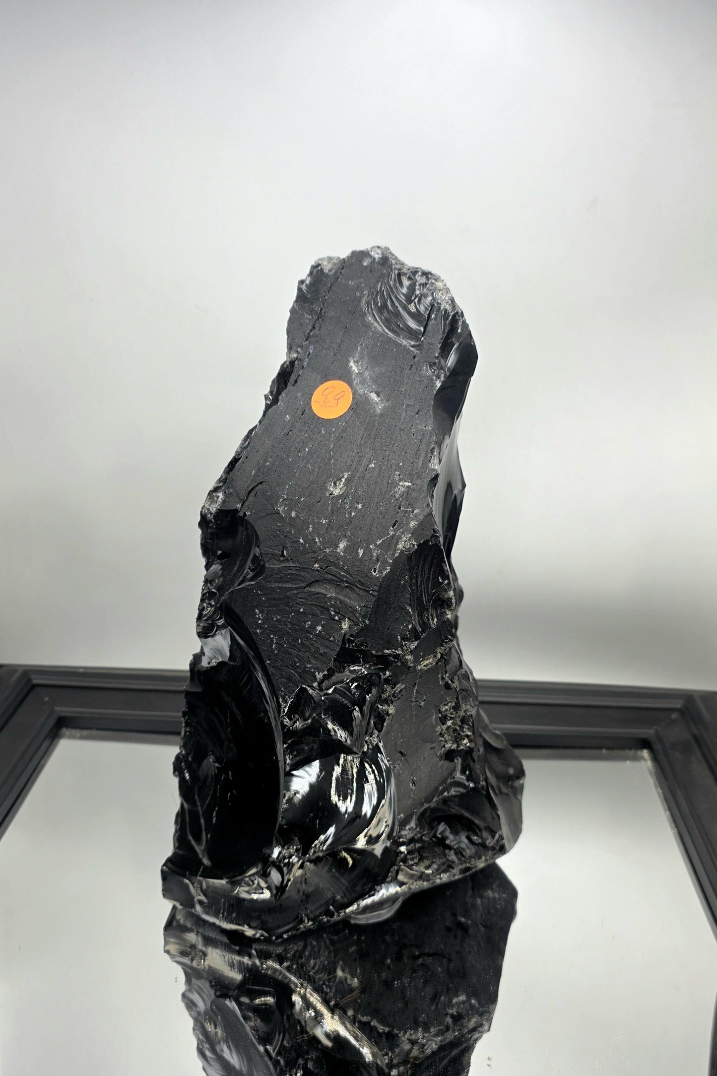 Raw obsidian crystal styled with linen textures in a wabi-sabi interior.