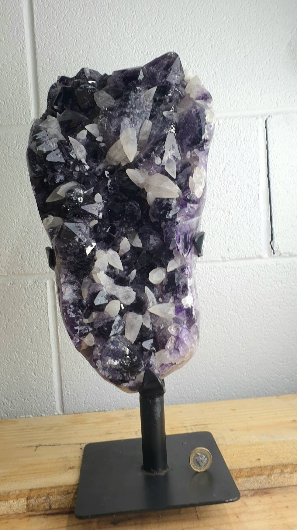 large amethyst crystal on stand