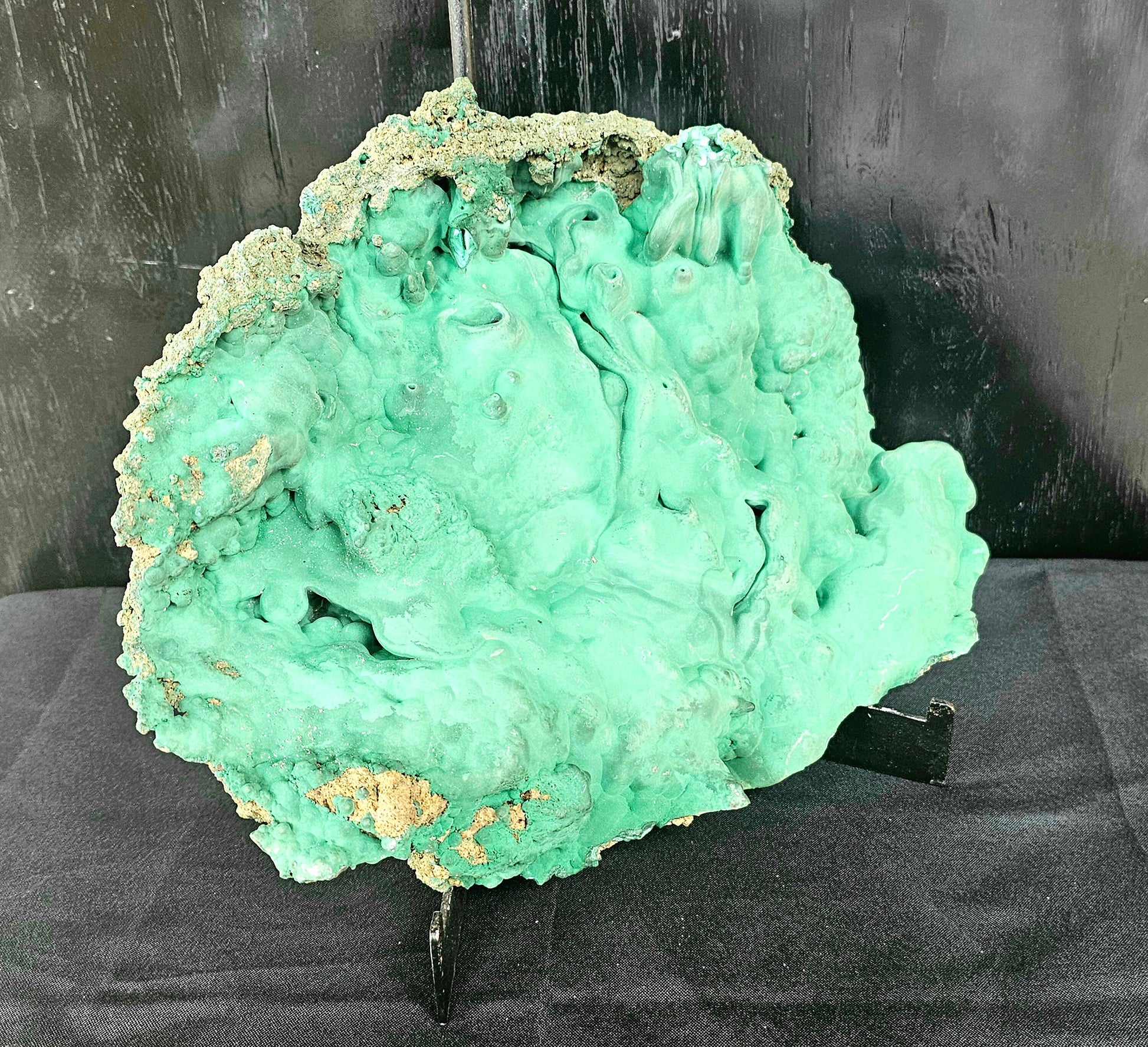 large malachite crystal on stand