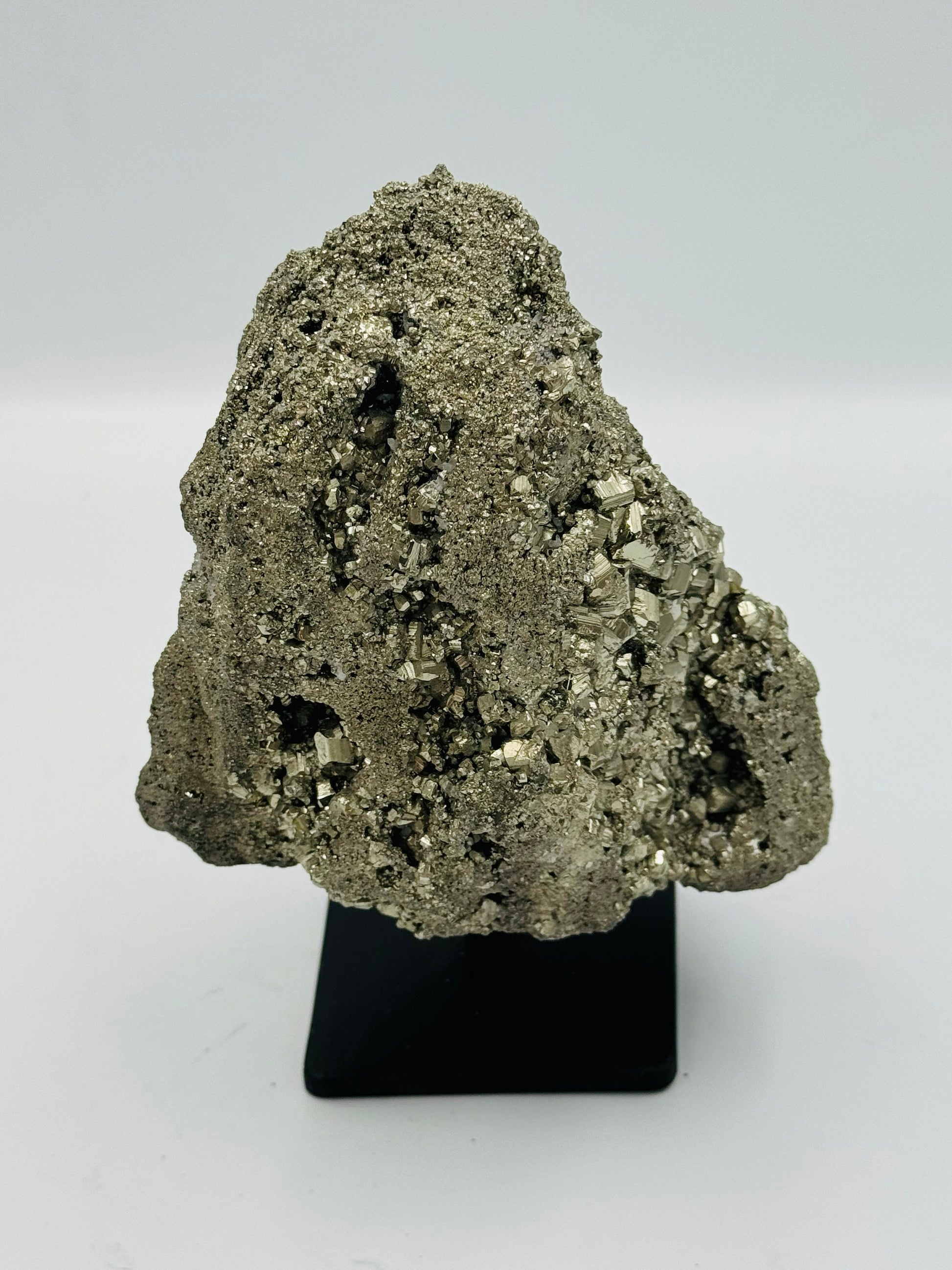 large pyrite crystal on display stand