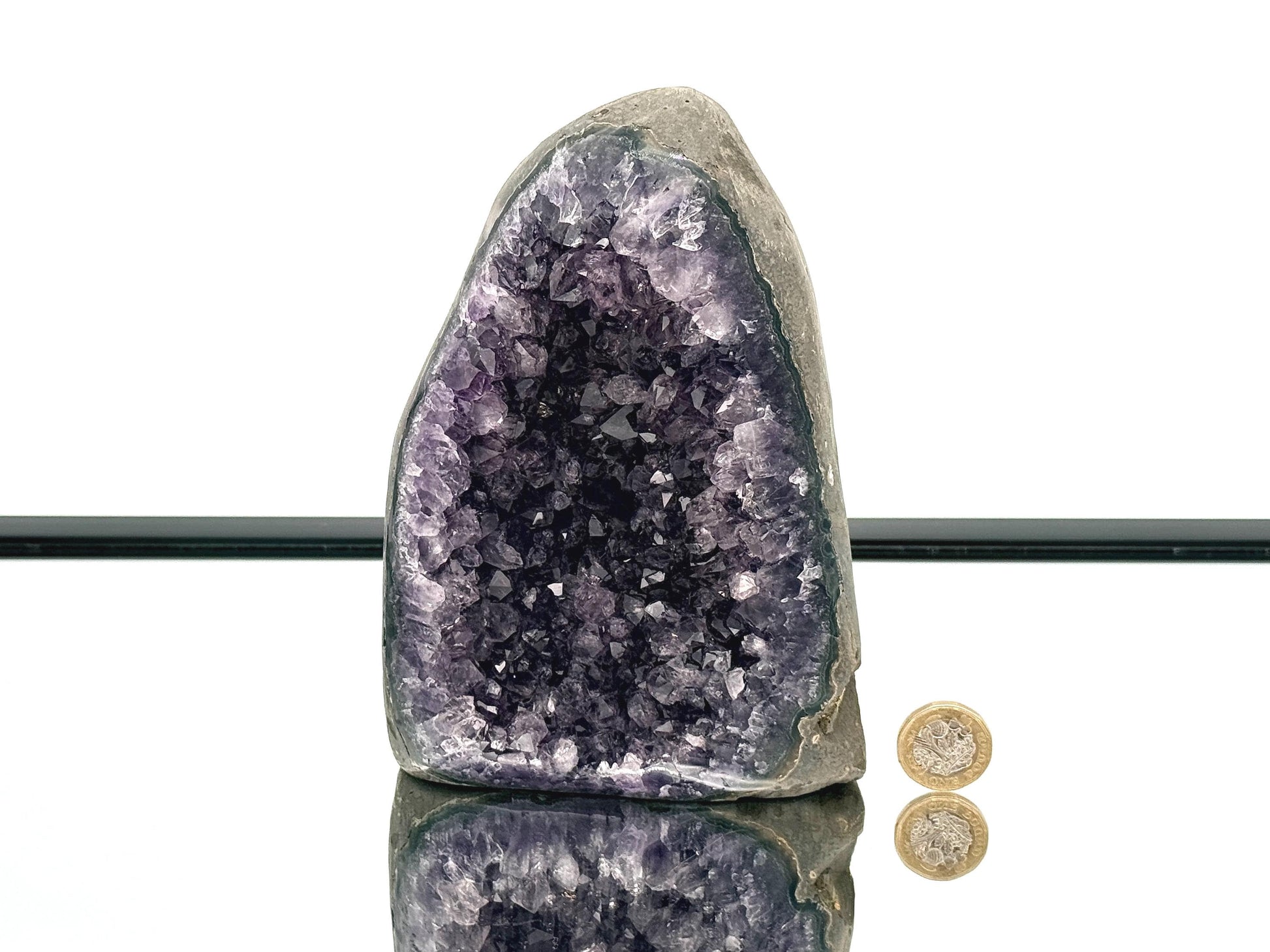 Large Uruguayan Amethyst Crystal Geode with polished sides reflecting light, showcasing vibrant purple amethyst crystals