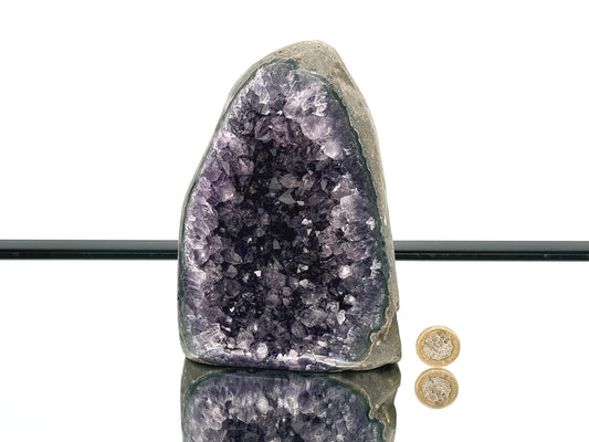 Large Uruguayan Amethyst Crystal Geode with polished sides reflecting light, showcasing vibrant purple amethyst crystals