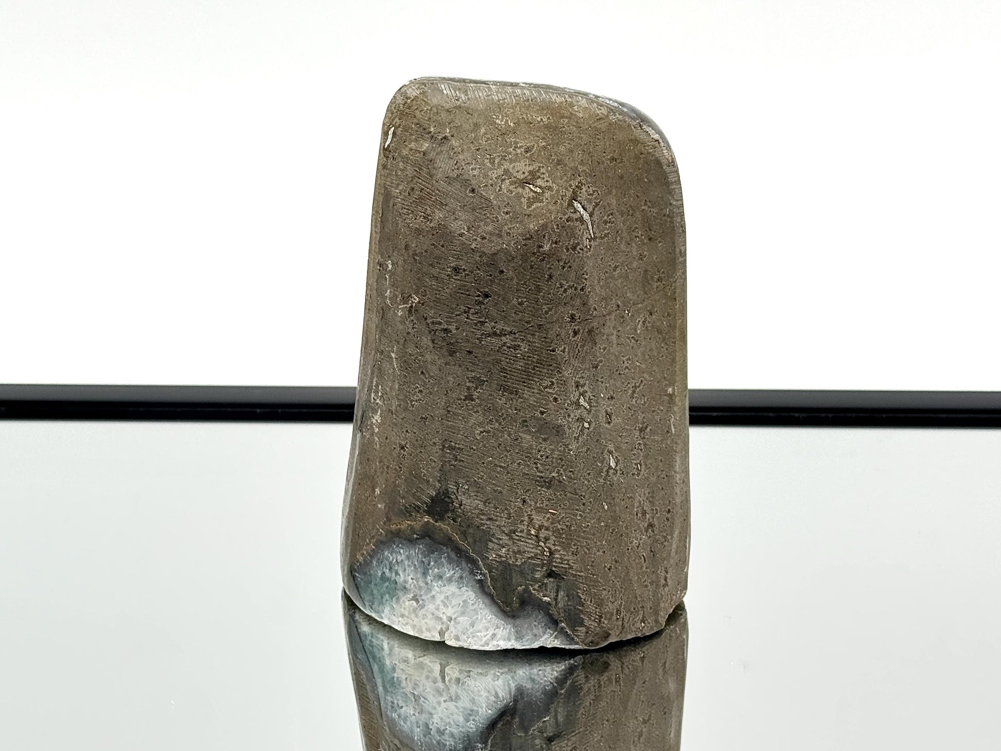 Large Uruguayan Amethyst Crystal Geode on mirror surface showcasing its polished surface and unique design.