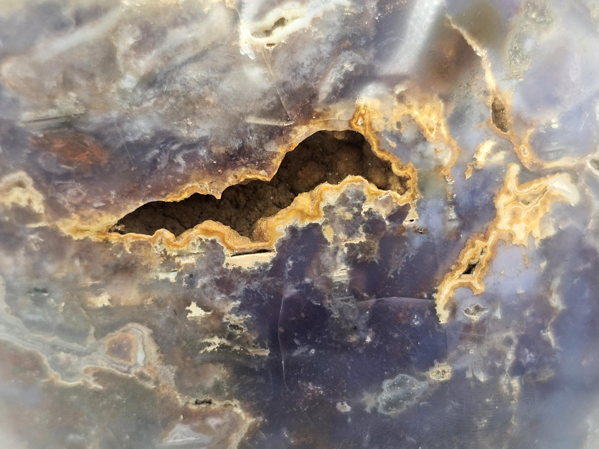 Detailed view of Madagascar violet agate crystal with reflective surfaces and natural formations