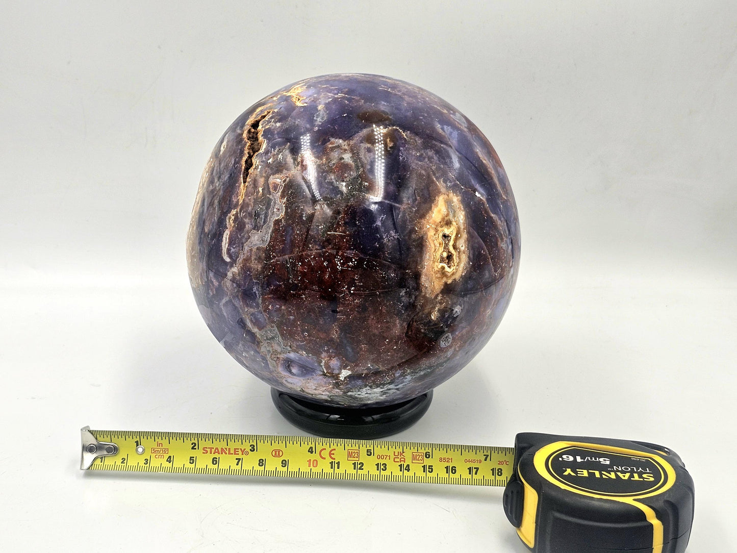 Madagascar-sourced violet agate crystal sphere radiating harmonious energy in a meditation space