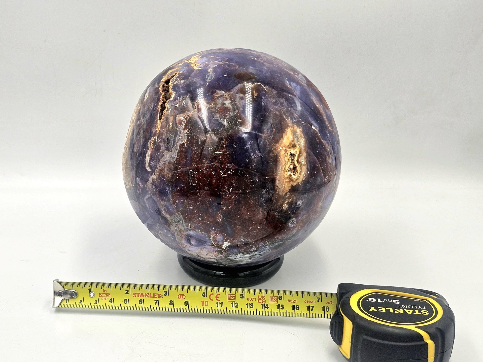 Madagascar-sourced violet agate crystal sphere radiating harmonious energy in a meditation space