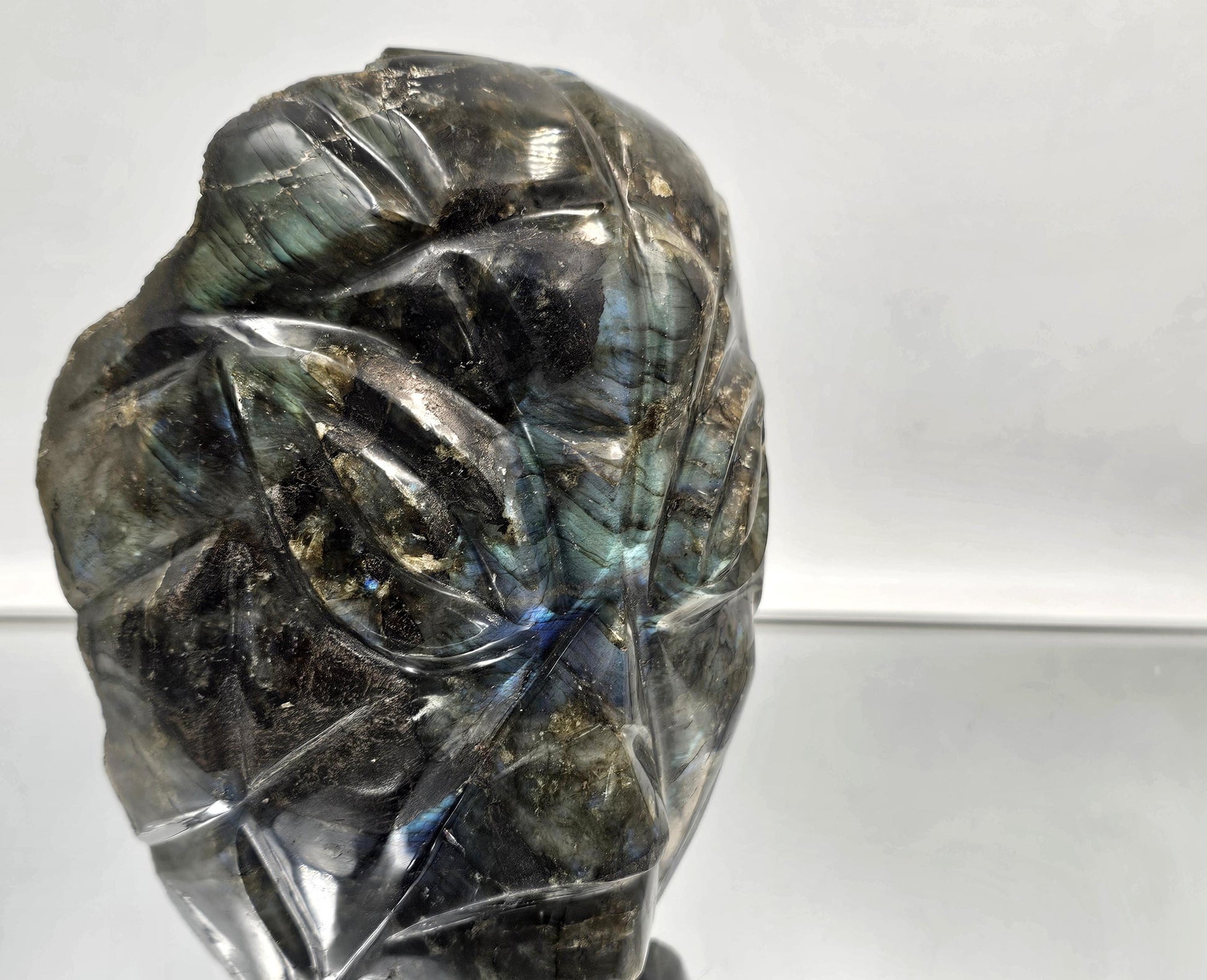 Madagascar Labradorite face carving showing vivid iridescence