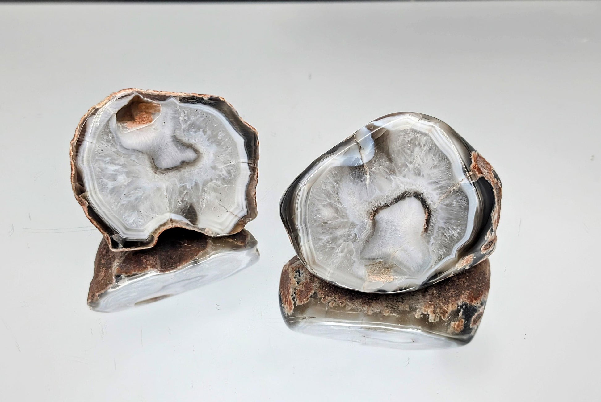 Natural agate specimens featuring prominent black bands.
