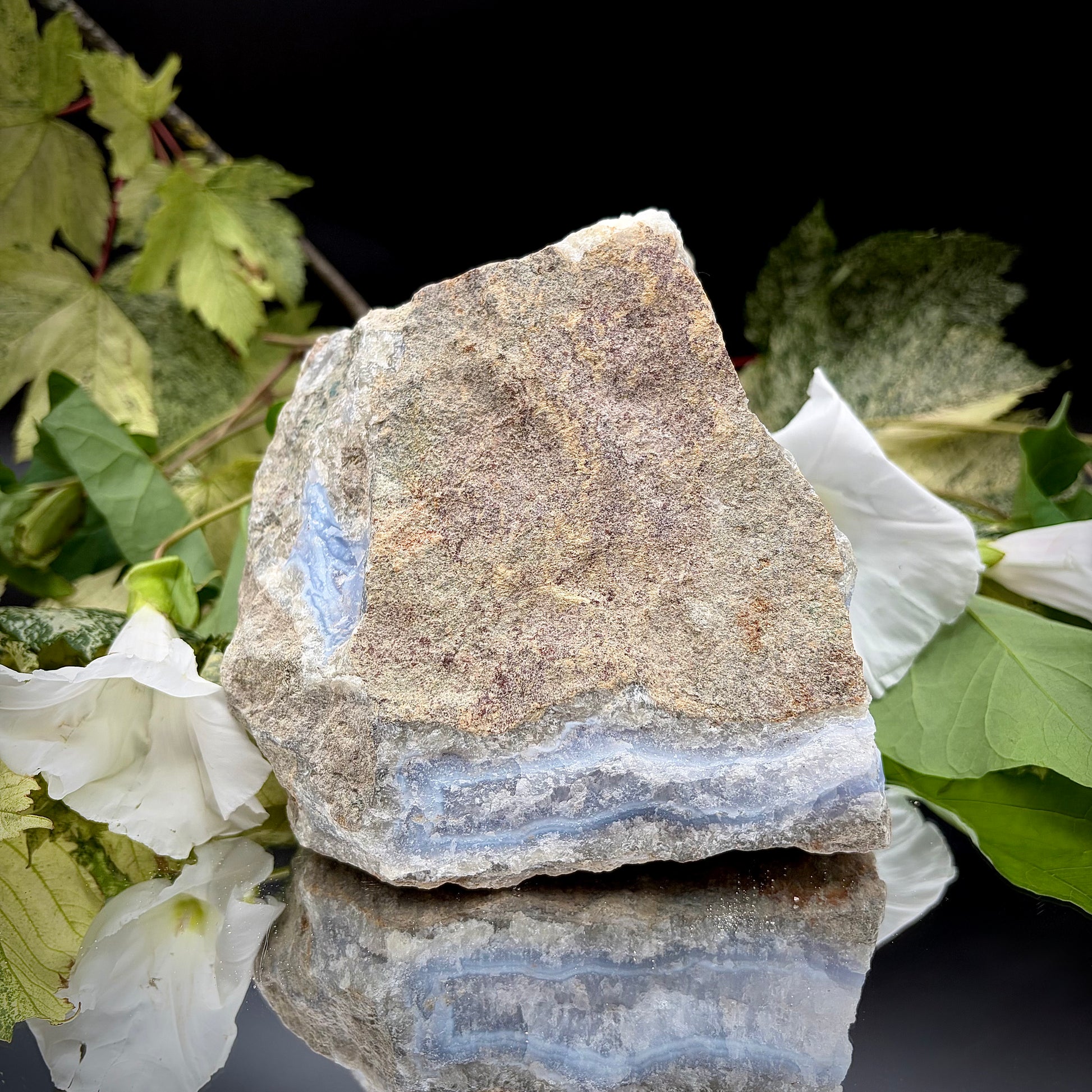 A side profile view of the raw Blue Lace Agate crystal cluster, emphasising its unique architectural shape and natural formation. 