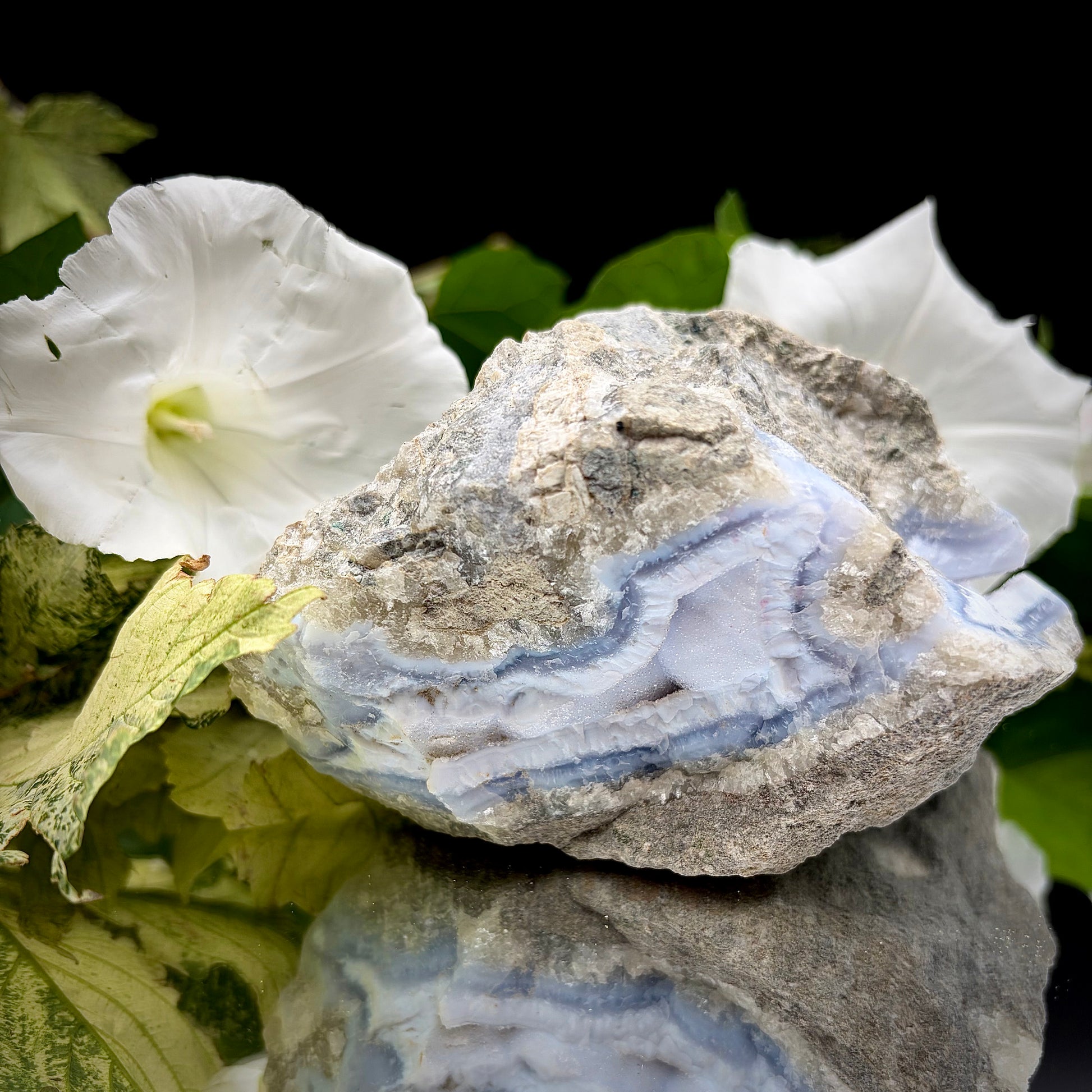 A side profile view of the raw Blue Lace Agate crystal cluster, emphasising its unique architectural shape and natural formation. 