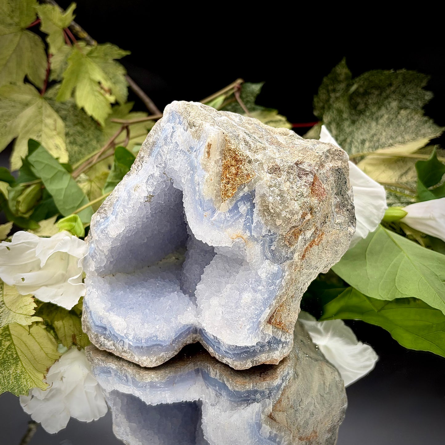 A side profile view of the raw Blue Lace Agate crystal cluster, emphasising its unique architectural shape and natural formation. 