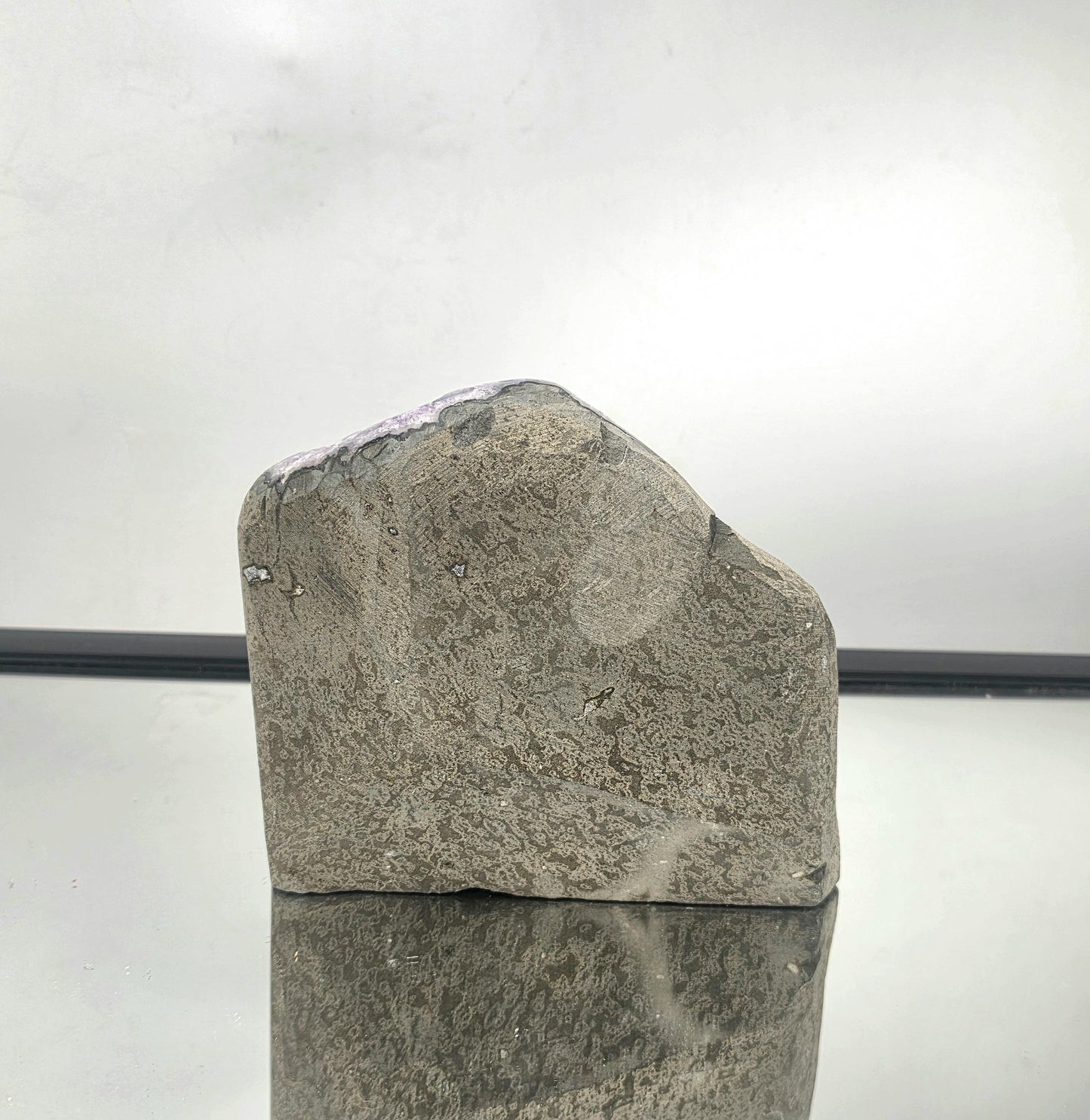 Basalt rock exterior of an amethyst geode from Uruguay, showcasing natural formation and mineral origin.