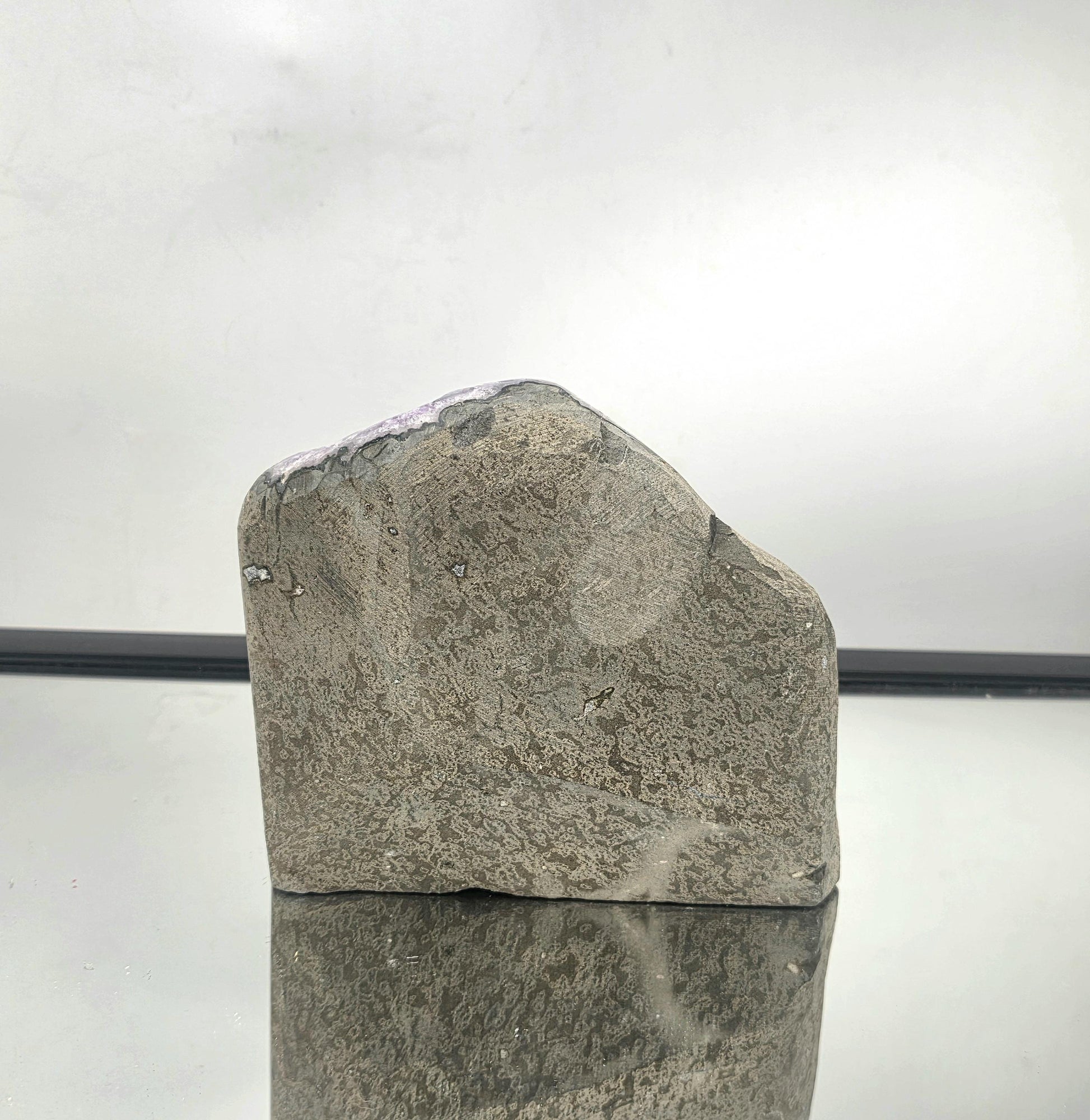 Basalt rock exterior of an amethyst geode from Uruguay, showcasing natural formation and mineral origin.