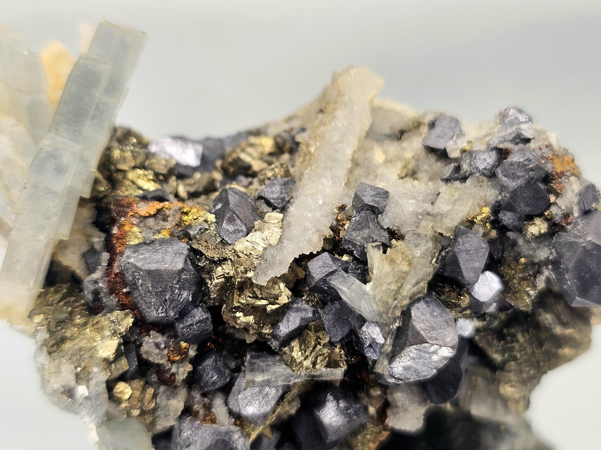 Close-up of Blue Baryte, Galena & Chalcopyrite combination crystal, highlighting the unique fusion of colors and mineral formations.