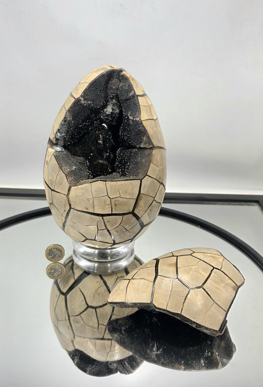 Large black septarian crystal egg with removable face.
