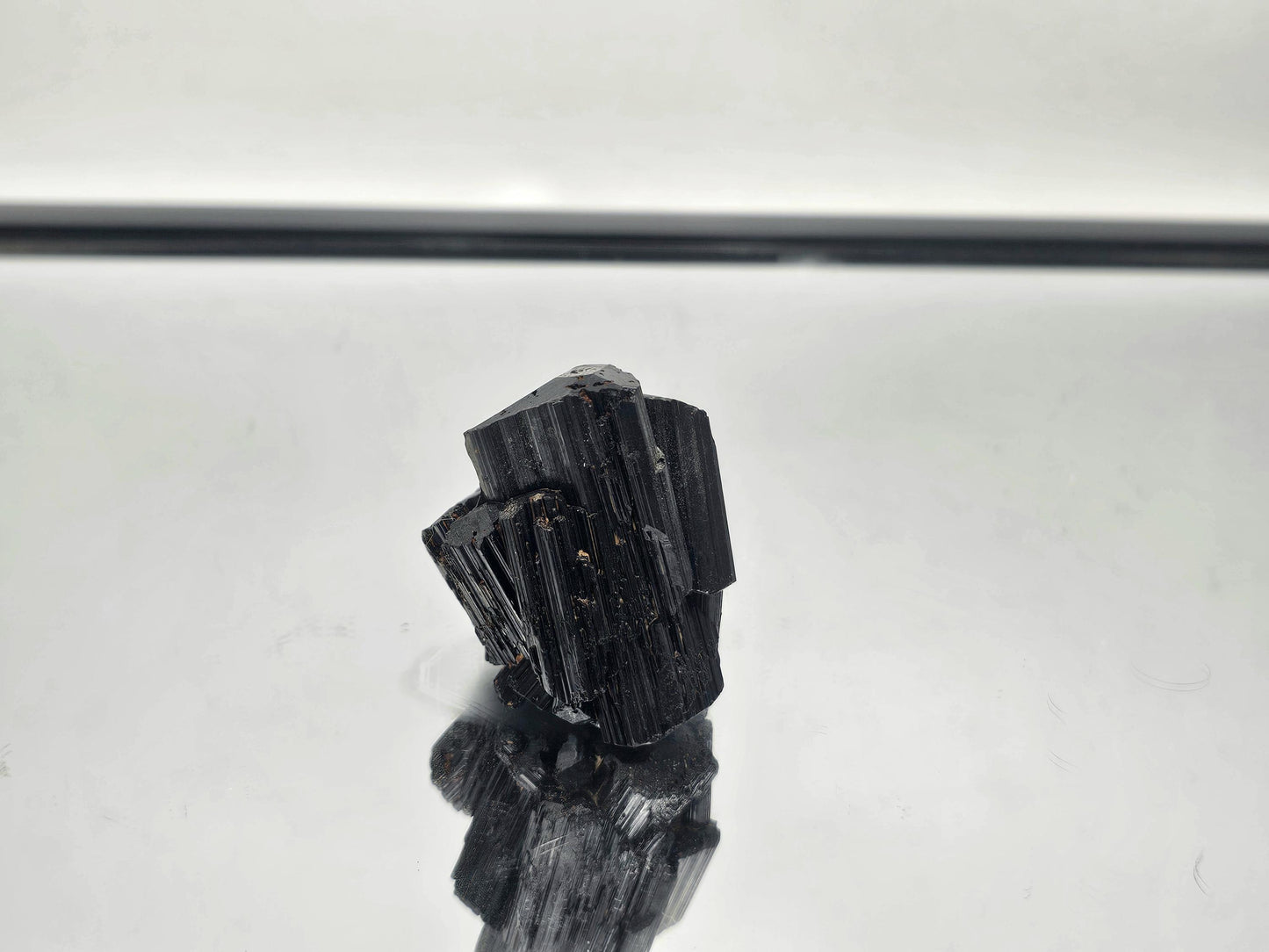 Raw Black Tourmaline crystal, perfect for grounding and protection, with unique natural formation.
