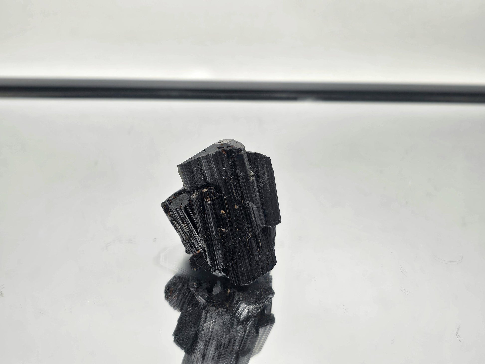 Raw Black Tourmaline crystal, perfect for grounding and protection, with unique natural formation.
