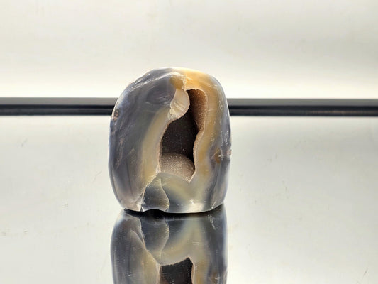 Striking natural Blue & White Agate crystal freeform, featuring a hollow center and elegant color patterns.