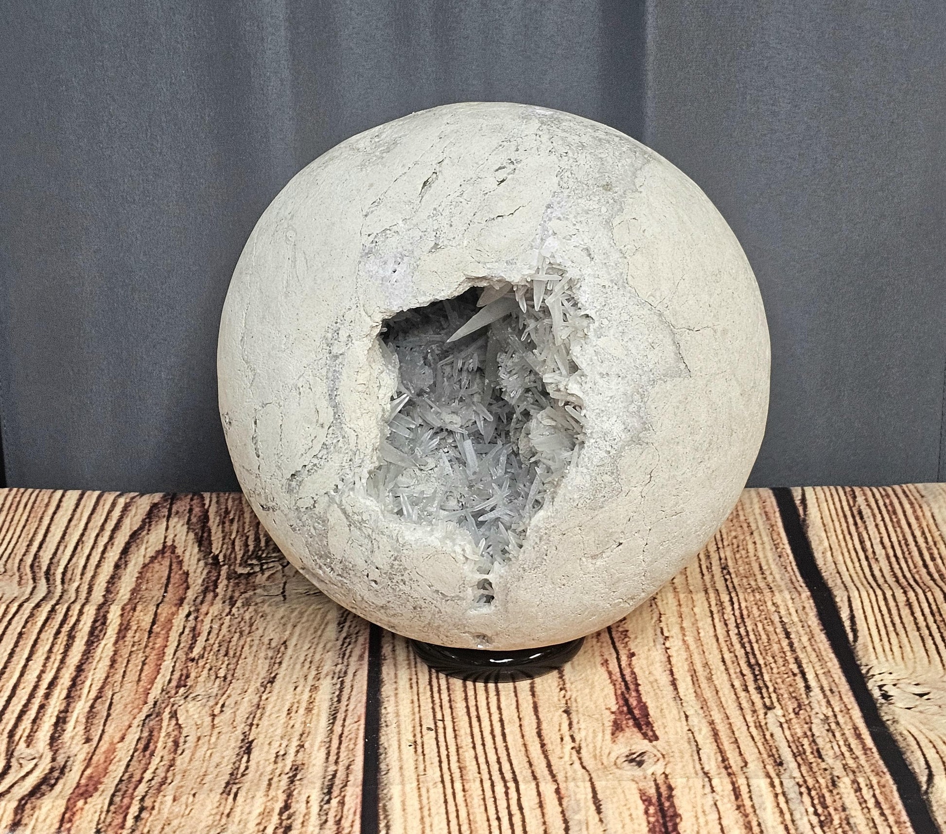 Natural Celestite Geode Sphere with a shimmering surface and delicate internal crystal structures.