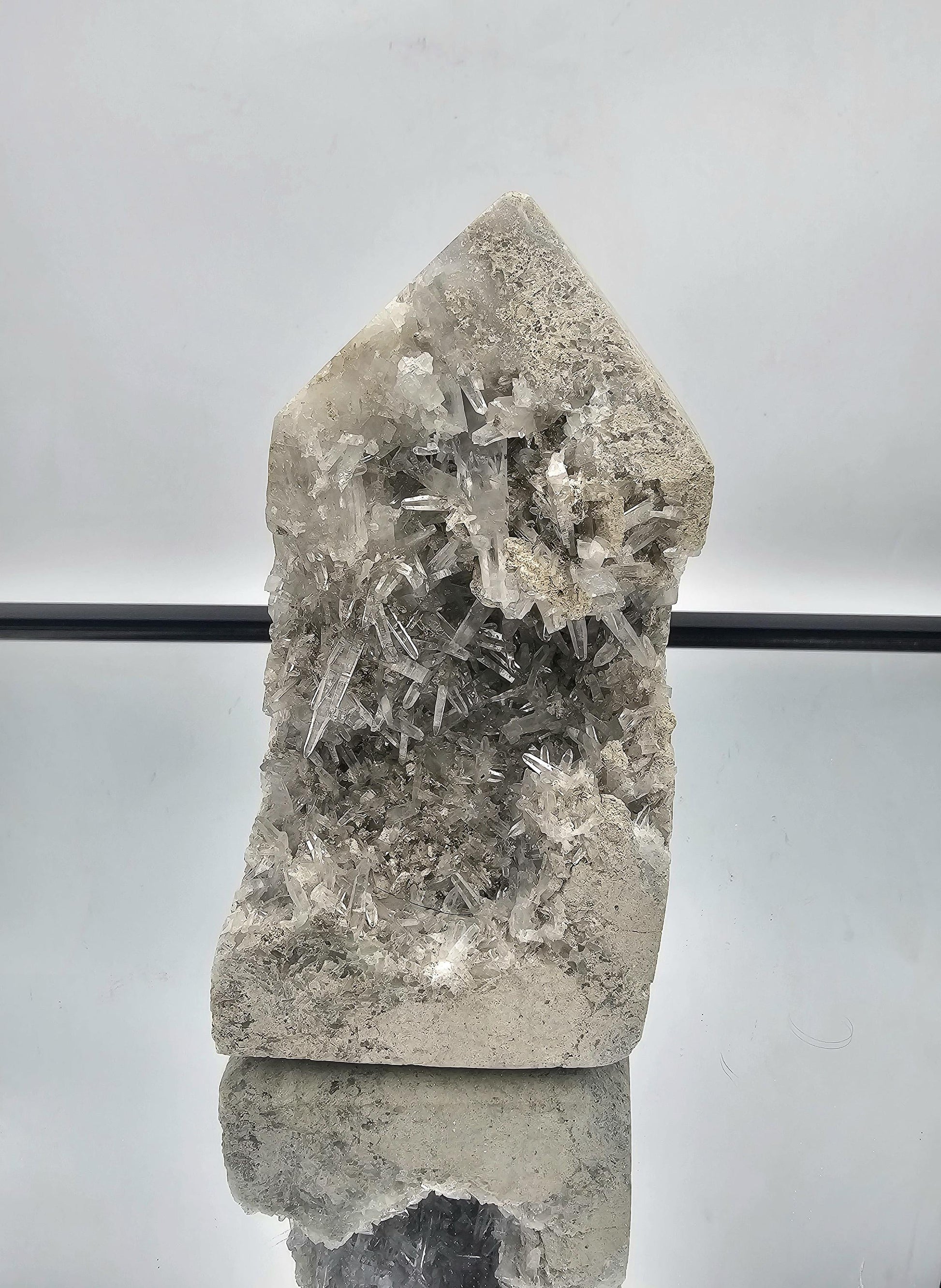 Large Celestite geode prism with fine needle crystals, showcasing soft blue hues and unique crystal formations.