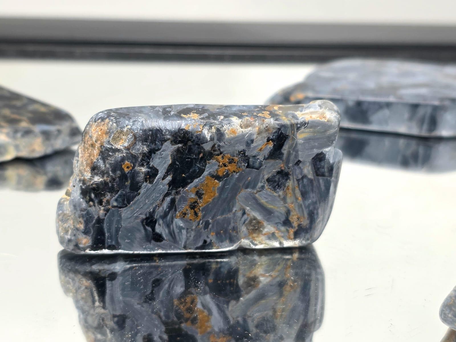 Pietersite crystal slice showing blue and gold colours