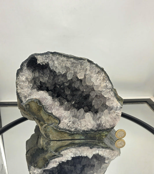 Large clear quartz geode with sparkling crystal interiors.