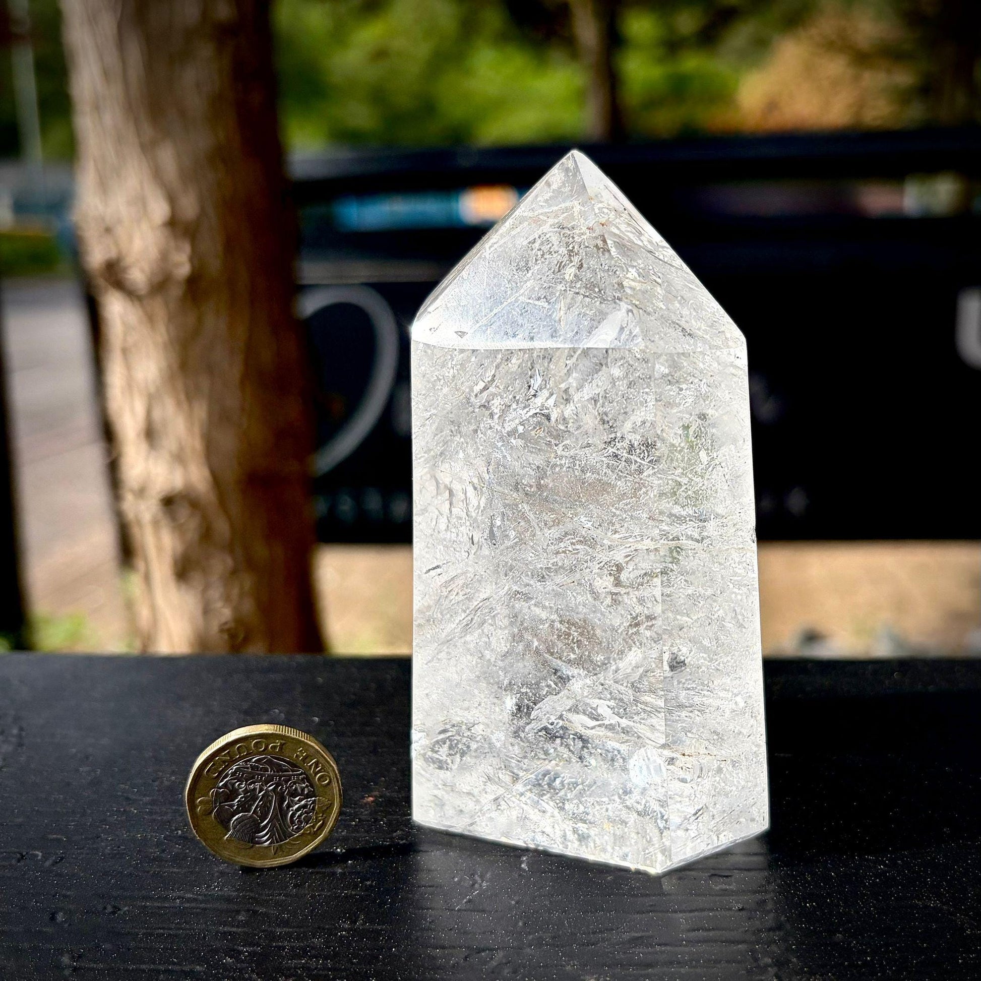 Clear quartz crystal tower styled as elegant home decor for shelves, desks, sideboards and interiors.