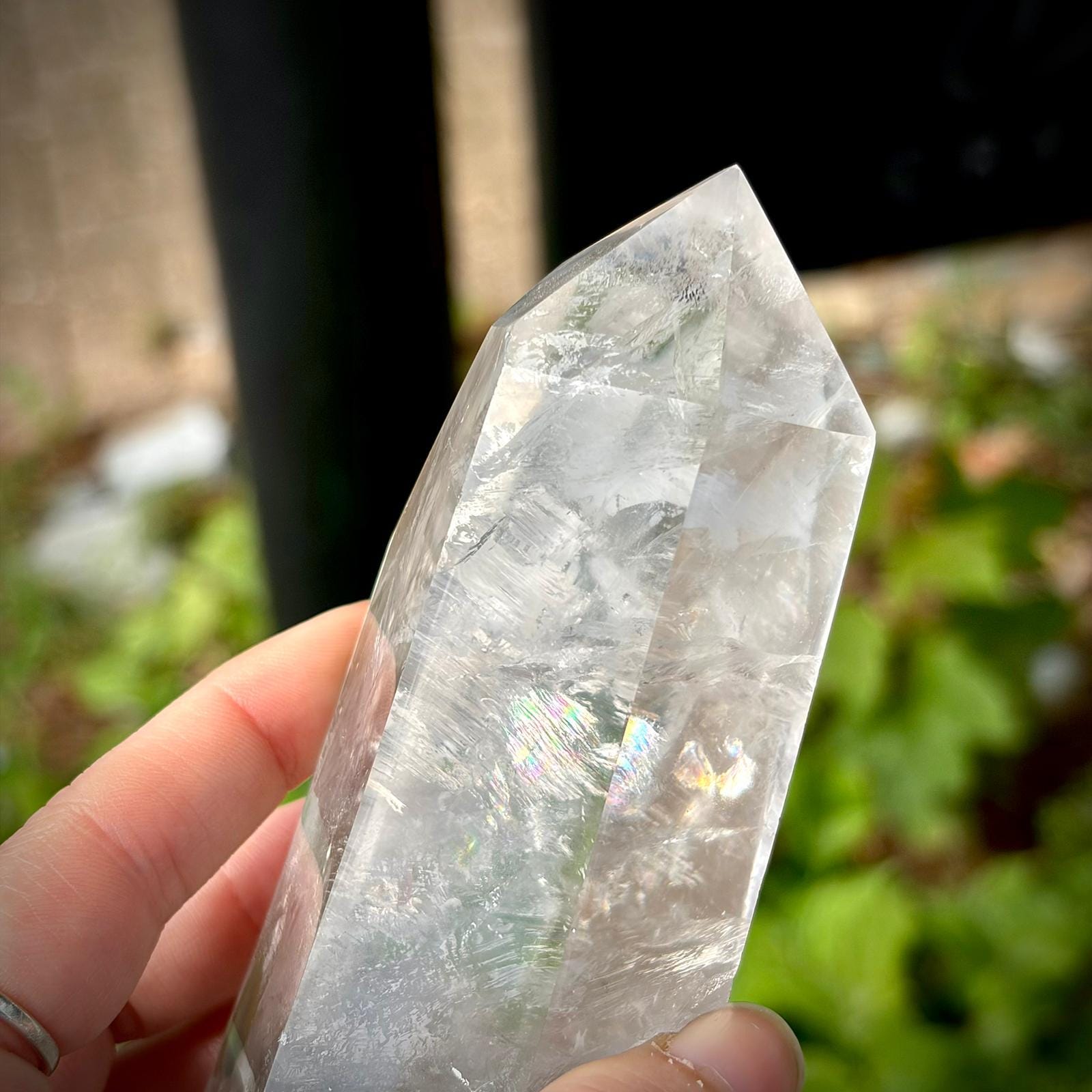 Clear quartz crystal tower polished to highlight natural veiling, clarity and surface detail.
