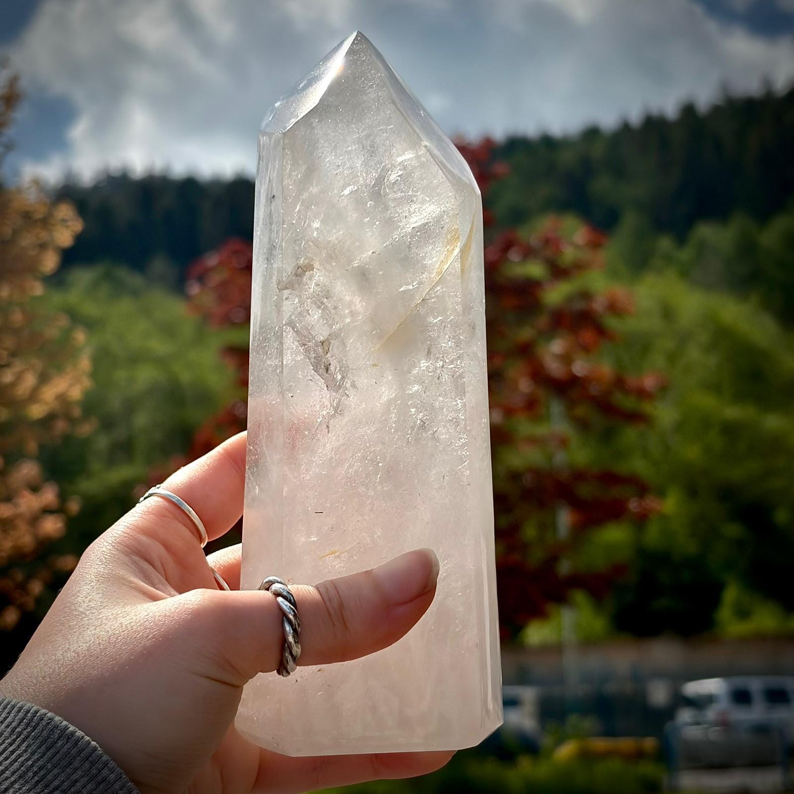 Clear quartz tower with natural rainbow detail, polished finish and elegant display appeal for home decor.
