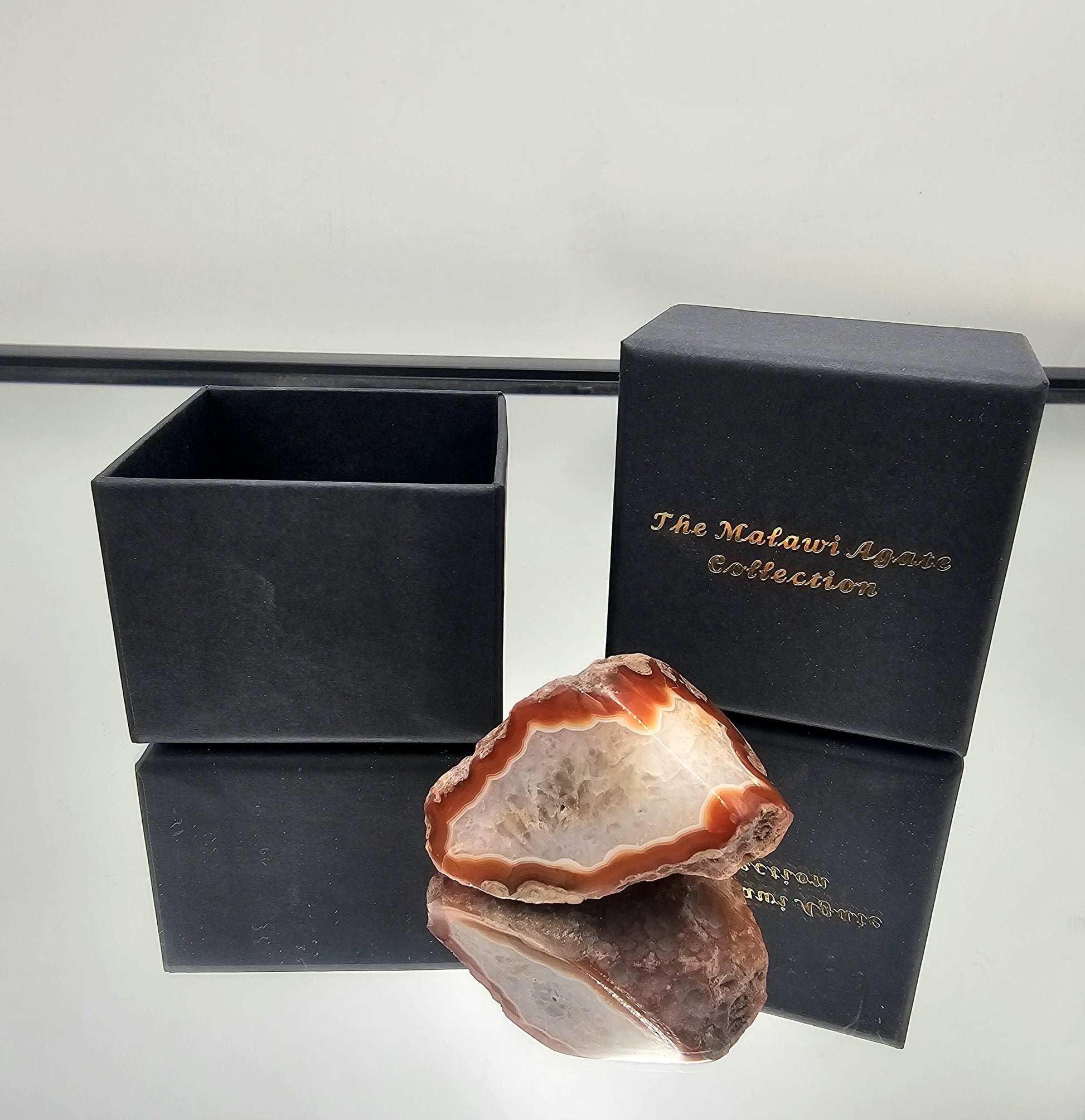 Colorful banded Malawi agate gemstone with a high-gloss polish.