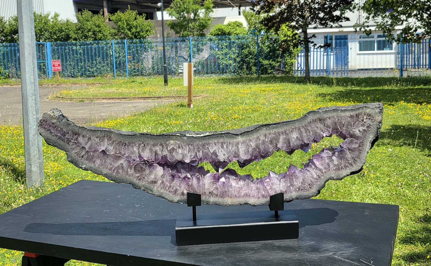 Custom metal stand supporting Brazilian amethyst portal.