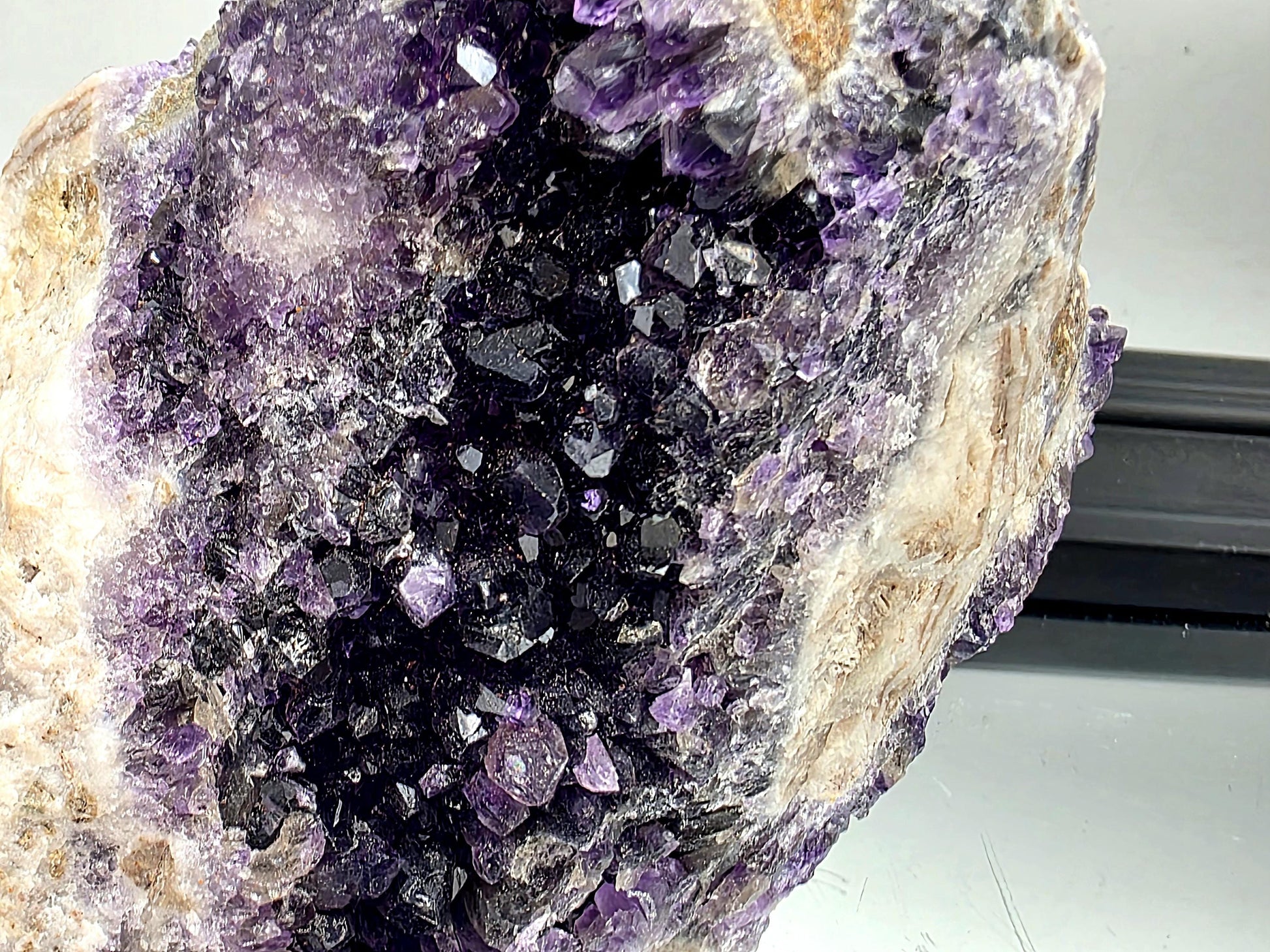 Dark violet Mapatizya amethyst cluster for display.
