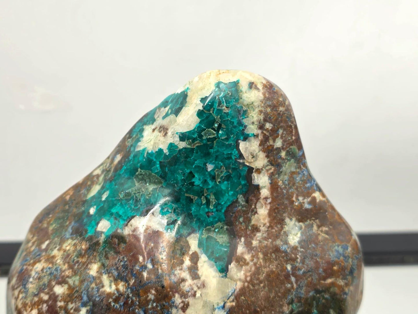 Luxury mineral display featuring polished dioptase crystal