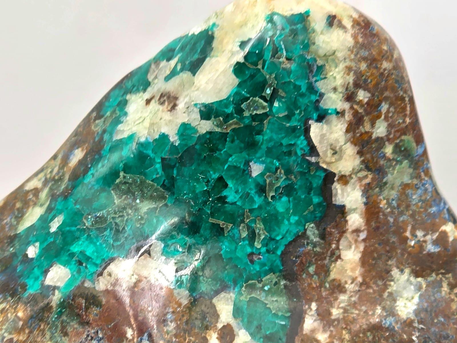 Detail shot of dioptase’s rich emerald hues and reflective surface