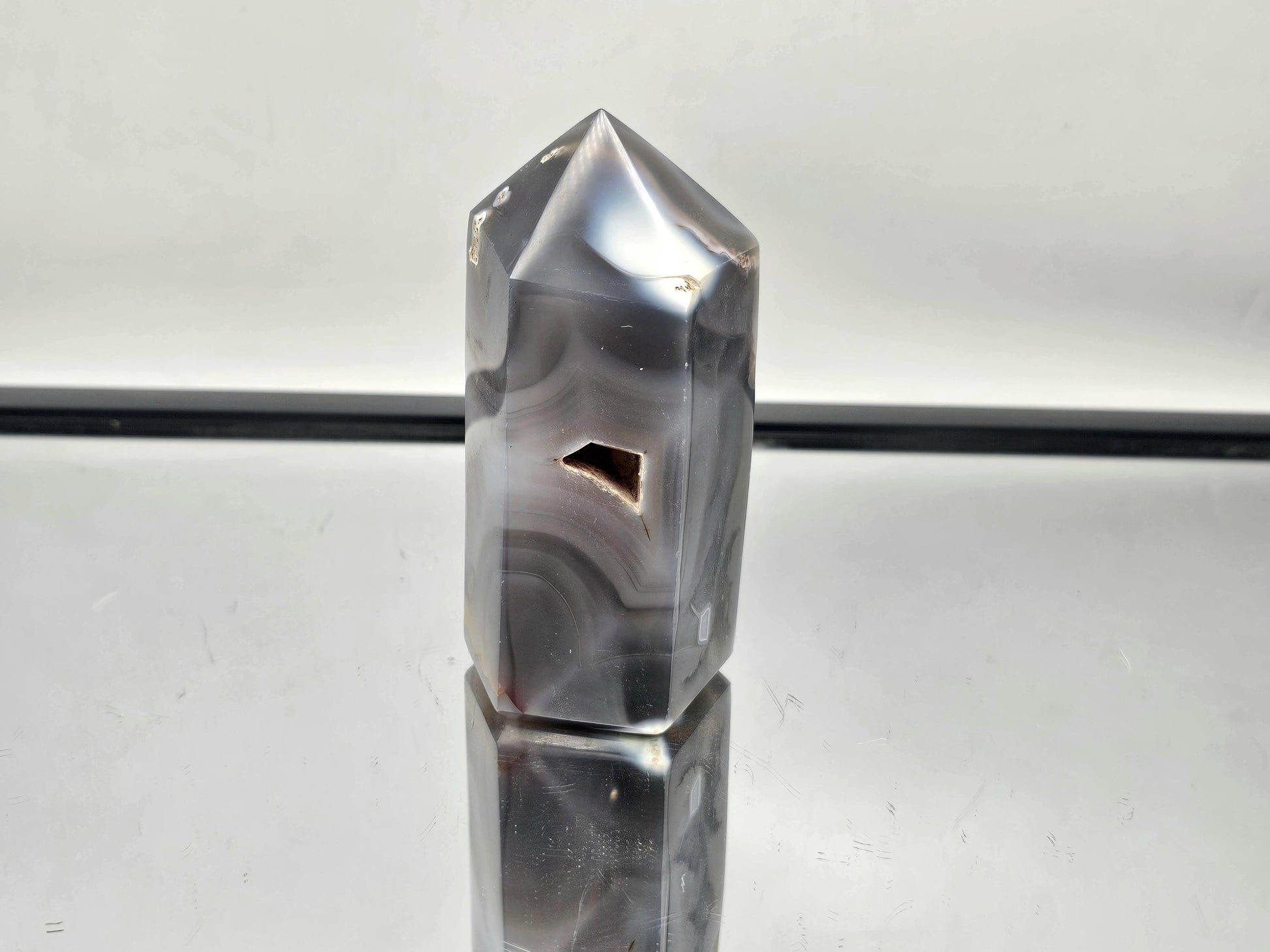 Elegant Orca Agate crystal point, perfect for energy healing.