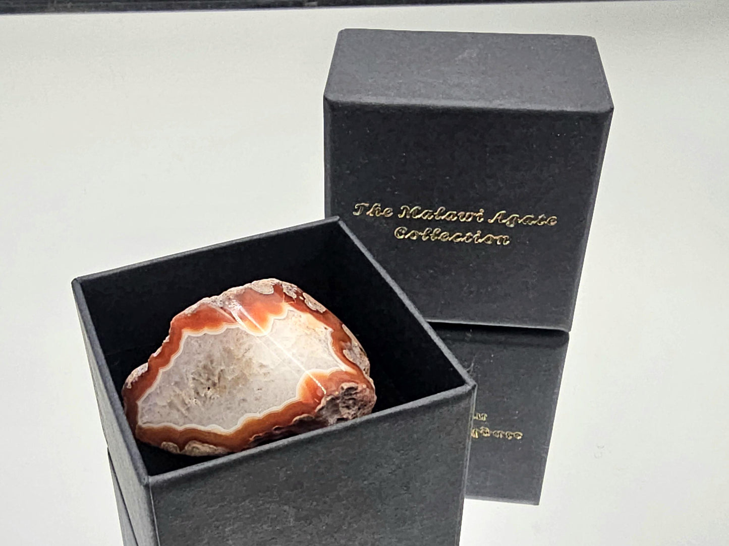 Exclusive Malawi agate collection piece, polished and displayed in a luxury box.