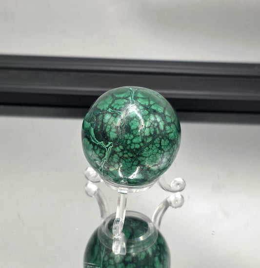Malachite sphere with natural flower-like patterns.