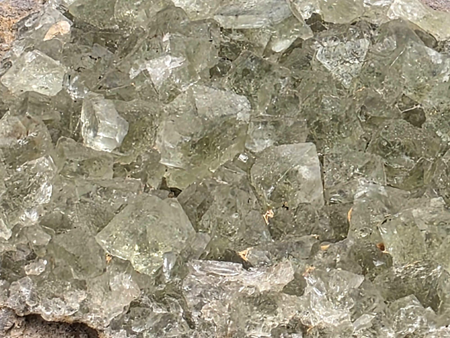 Fluorite specimen with pale green transparent crystals and natural matrix.