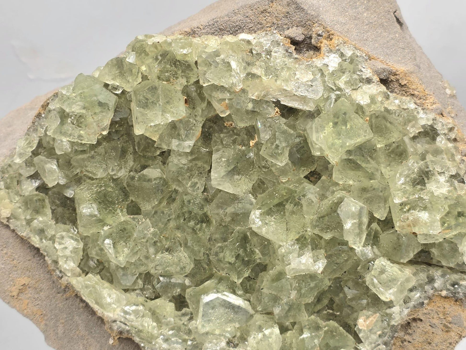 Green fluorite octahedral crystals on natural marl matrix from Morocco.