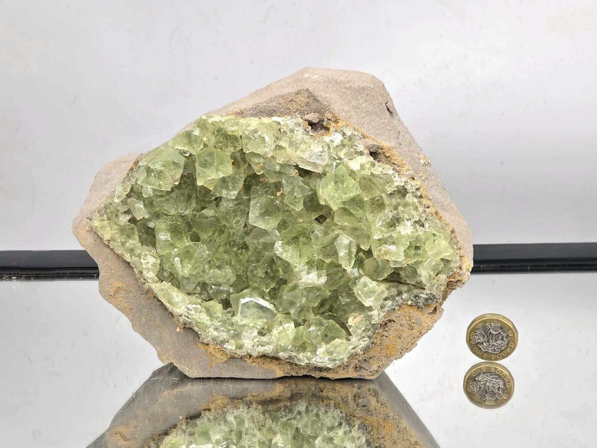 Fluorite specimen with pale green transparent crystals and natural matrix.