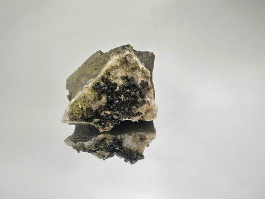 Forest Epidote on Quartz fine mineral with vibrant green hues