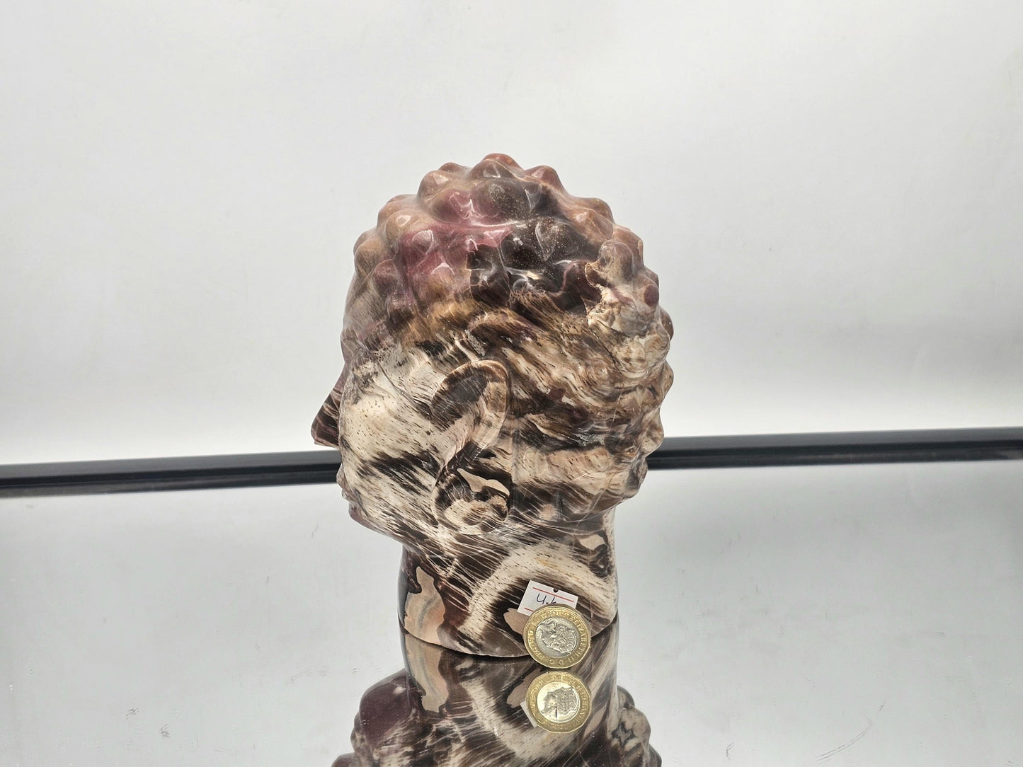 Artistic Fossil Wood Buddha carving, a unique handcrafted piece from Madagascar.
