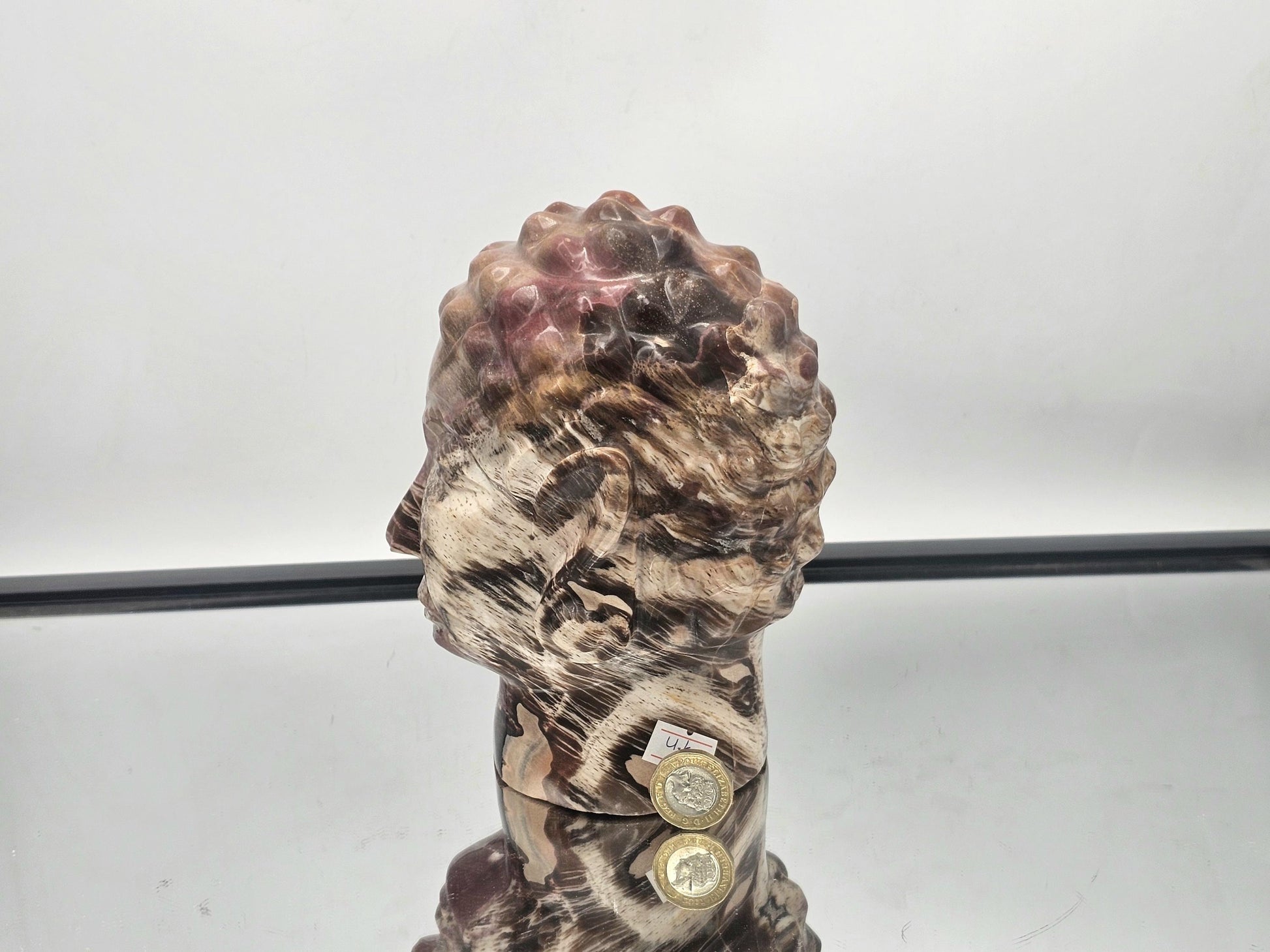 Artistic Fossil Wood Buddha carving, a unique handcrafted piece from Madagascar.
