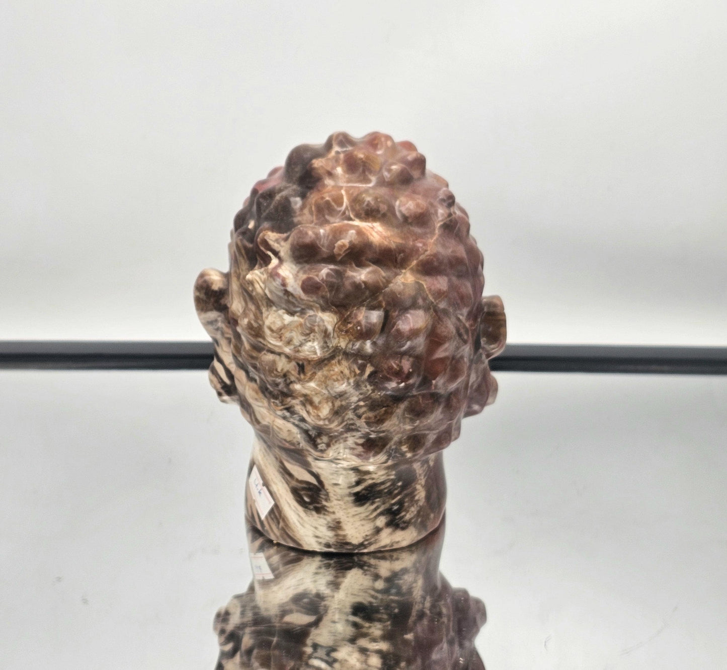 Fossil Wood Buddha Crystal Carving with intricate detailing and natural fossil textures.