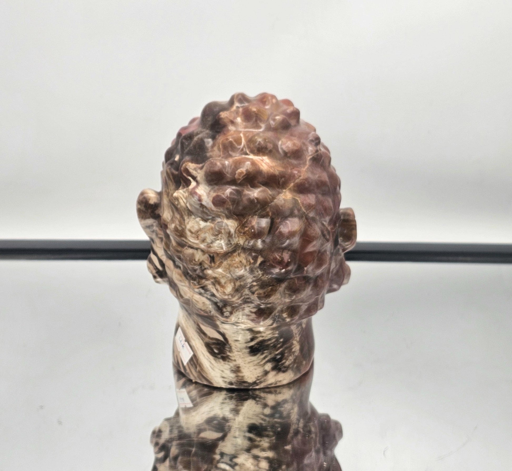 Fossil Wood Buddha Crystal Carving with intricate detailing and natural fossil textures.