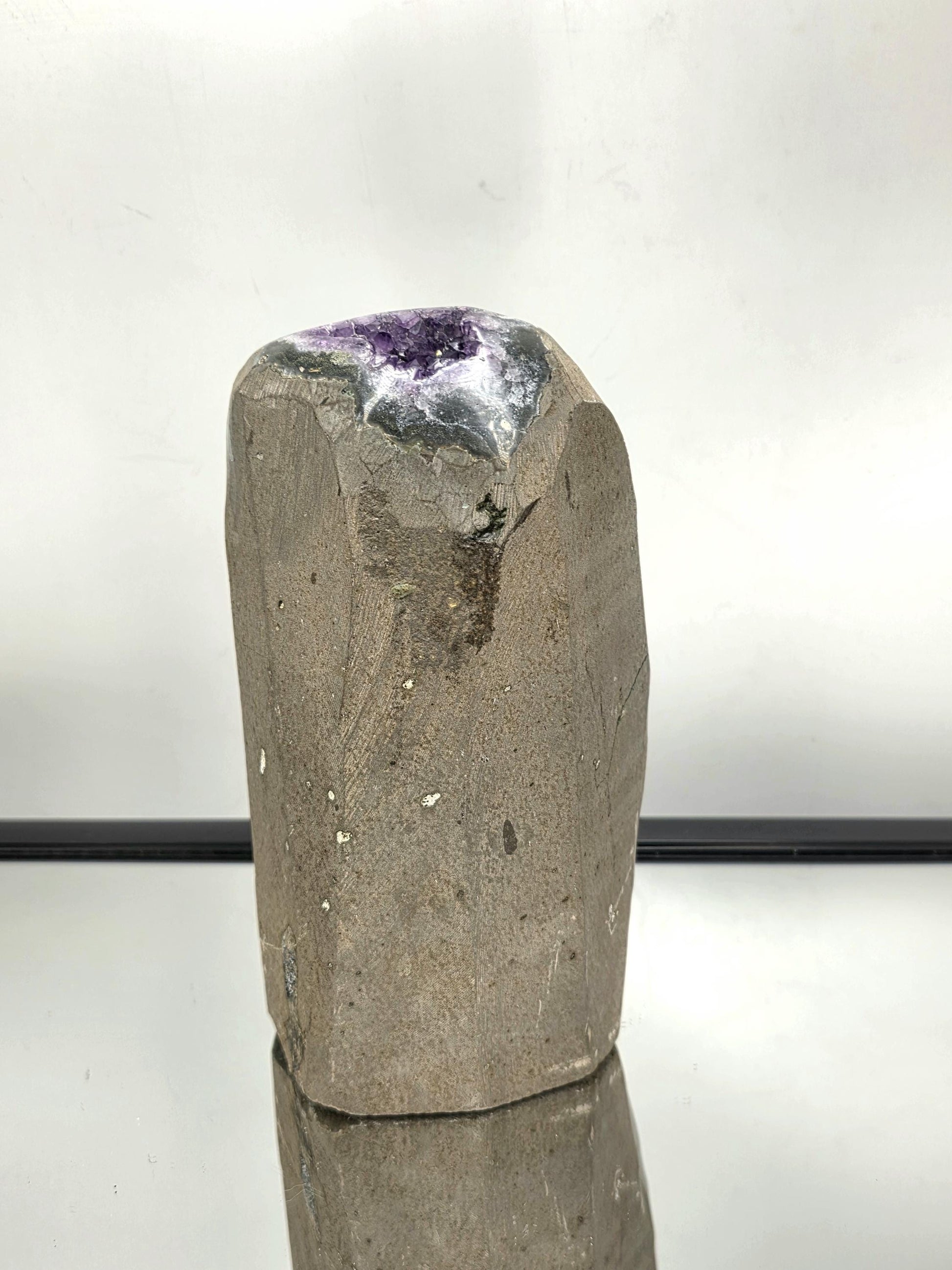 Freestanding natural Amethyst crystal with polished base