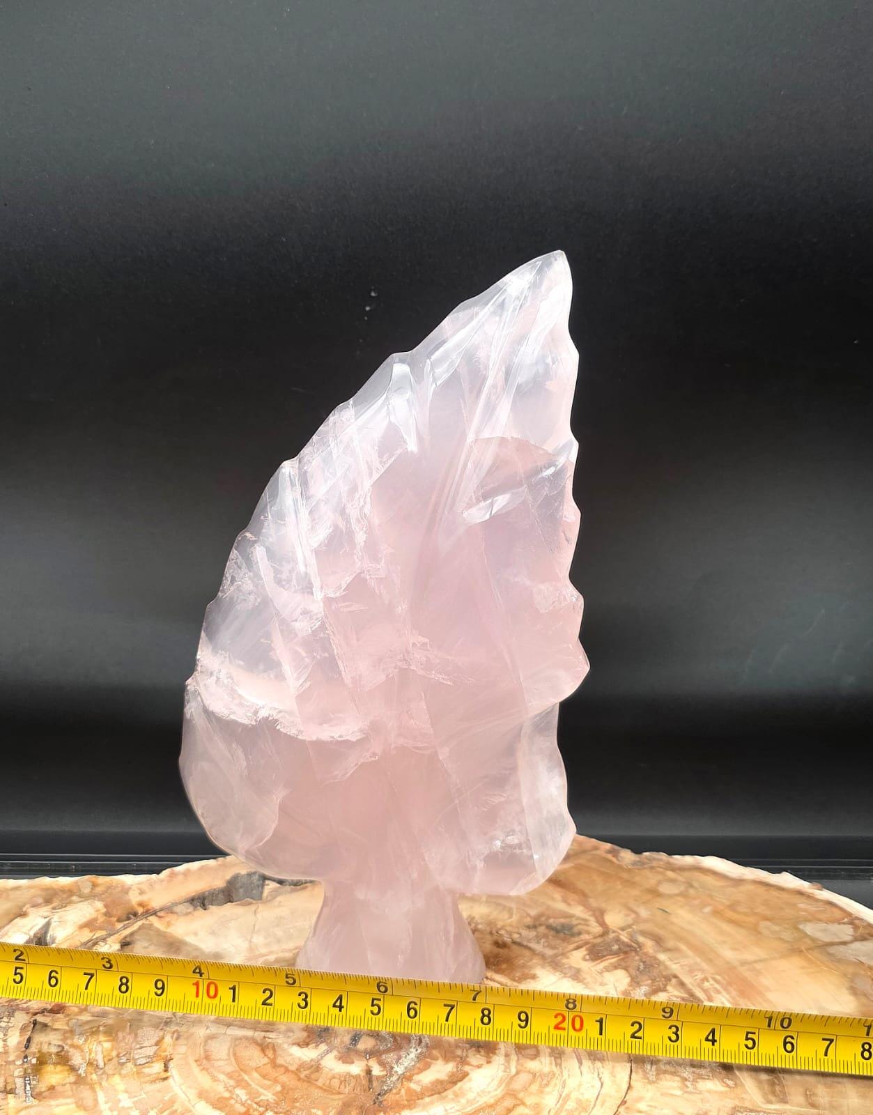 Hand-carved Rose Quartz crystal leaf showcasing natural translucency and polished finish.