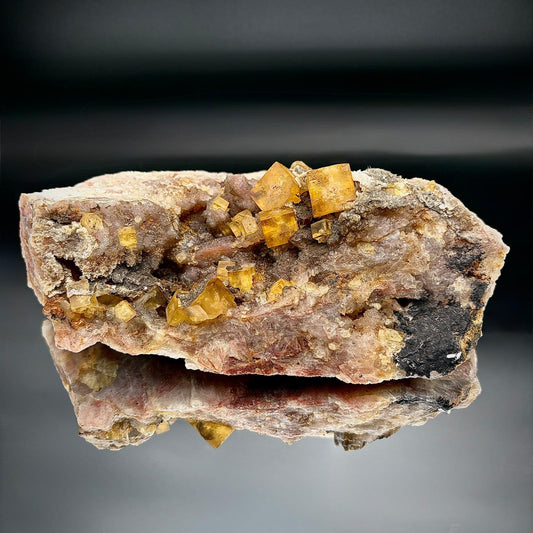 Golden yellow Fluorite crystal on black Hematite matrix