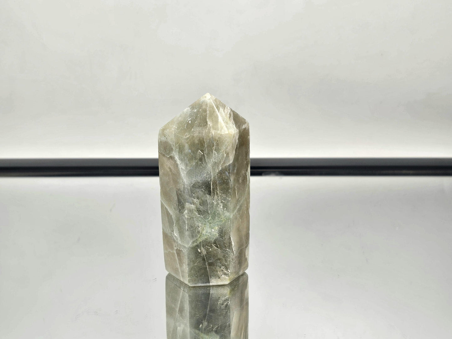 Elegant Green Moonstone crystal with garnet inclusions, part of our exclusive collection.