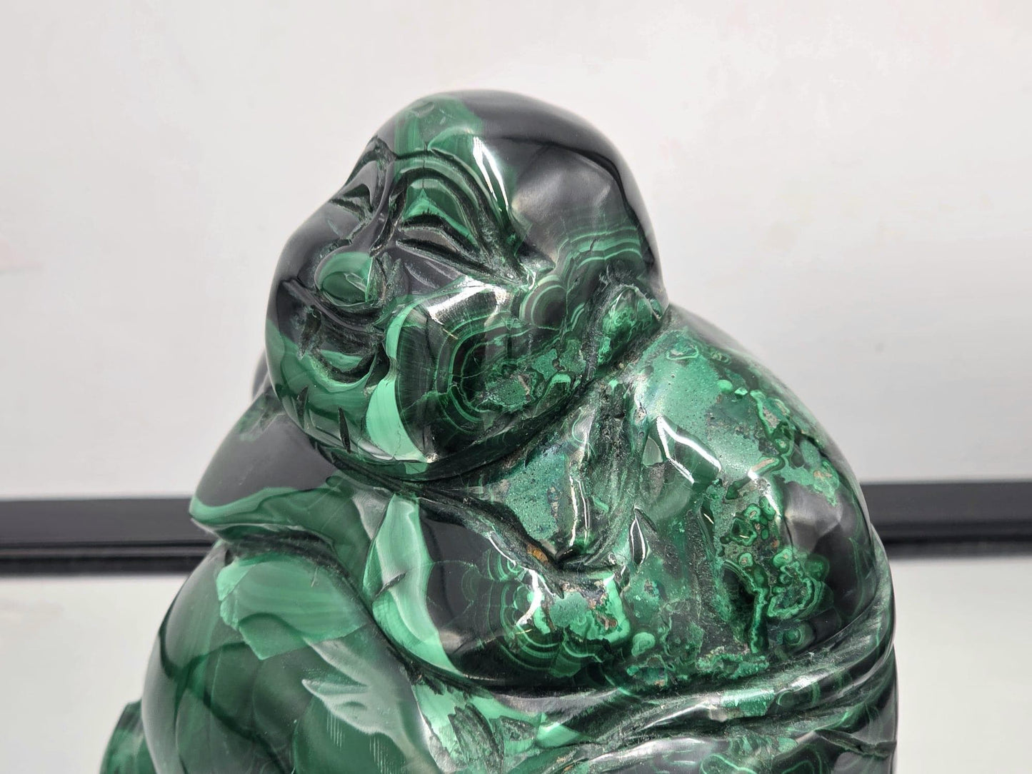 Hand-carved Malachite Buddha figure made from genuine malachite crystal, radiating grounding and heart-healing energy.